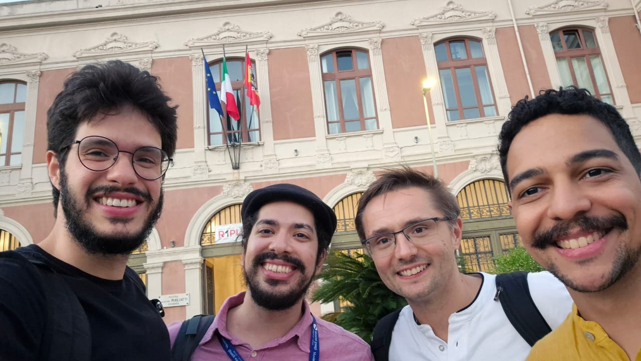 Group members and alumni outside the conference venue in Messina